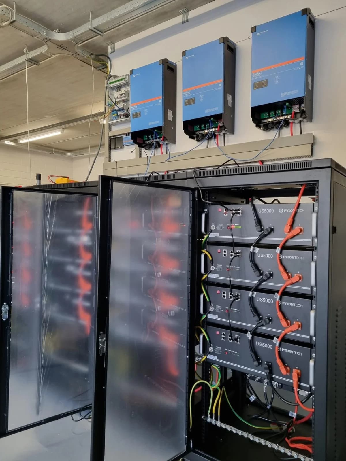 Totaalopstelling van 80 kWh energieopslag in het horecabedrijf, met drie Victron-omvormers en de geopende batterijkast